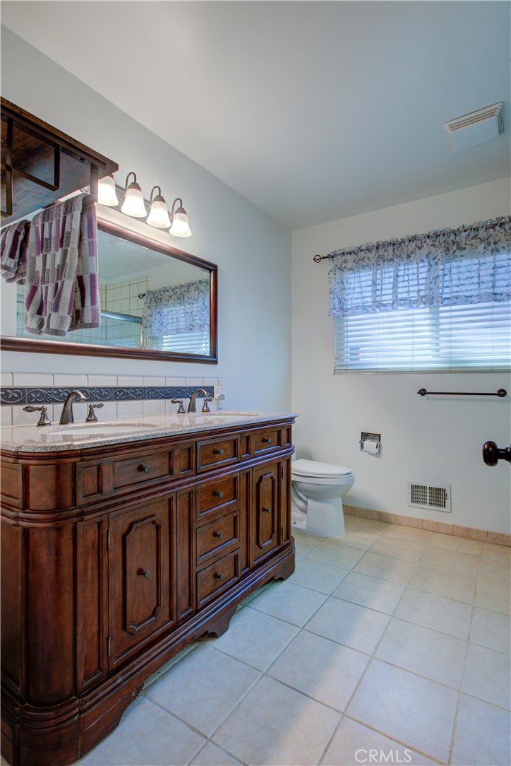 3728 Fuchsia Lane Modesto, CA 95356 - Photo 21 of 47 a bathroom with a sink a mirror and a toilet