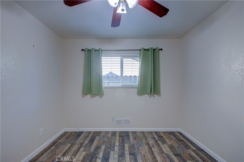 3728 Fuchsia Lane Modesto, CA 95356 - Photo 24 of 47 an empty room with wooden floor and windows