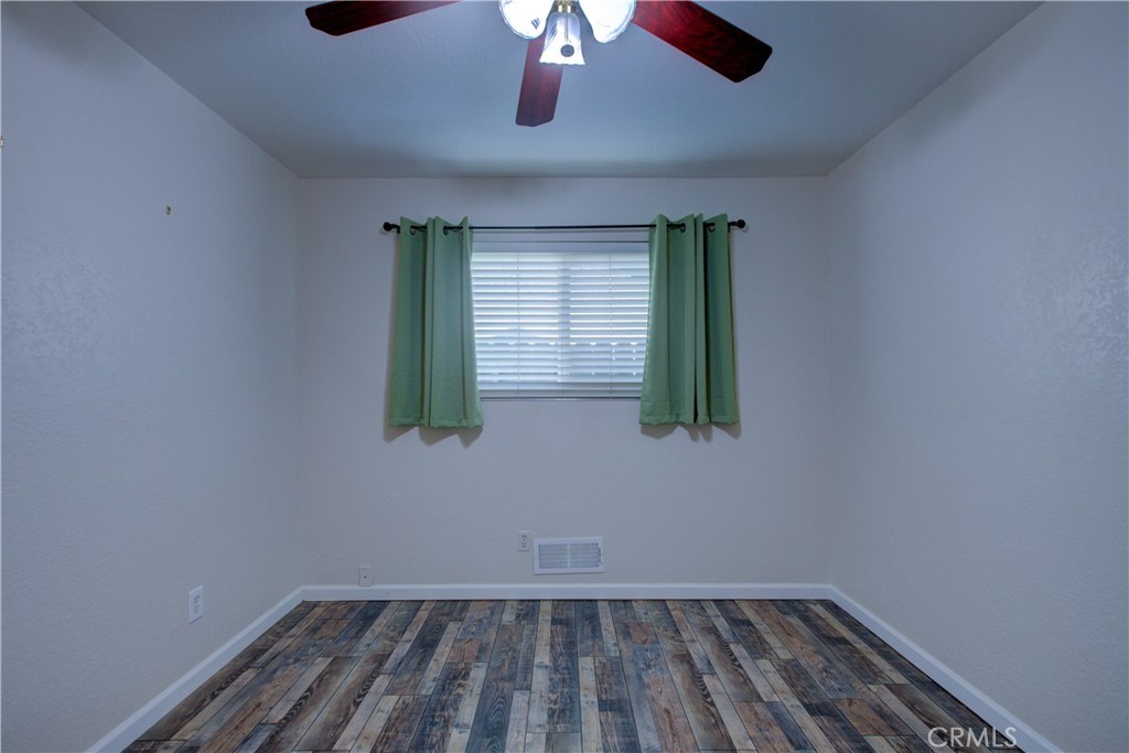 3728 Fuchsia Lane Modesto, CA 95356 - Photo 25 of 47 an empty room with wooden floor and windows