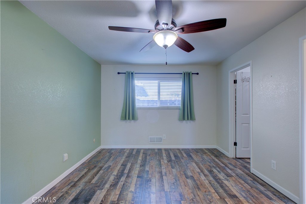 3728 Fuchsia Lane Modesto, CA 95356 - Photo 27 of 47 a view of empty room with wooden floor and fan