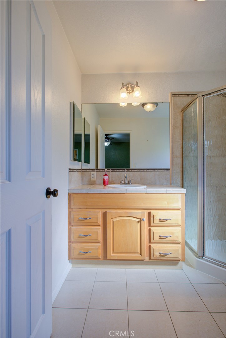 3728 Fuchsia Lane Modesto, CA 95356 - Photo 31 of 47 a bathroom with a sink a mirror and a bathtub