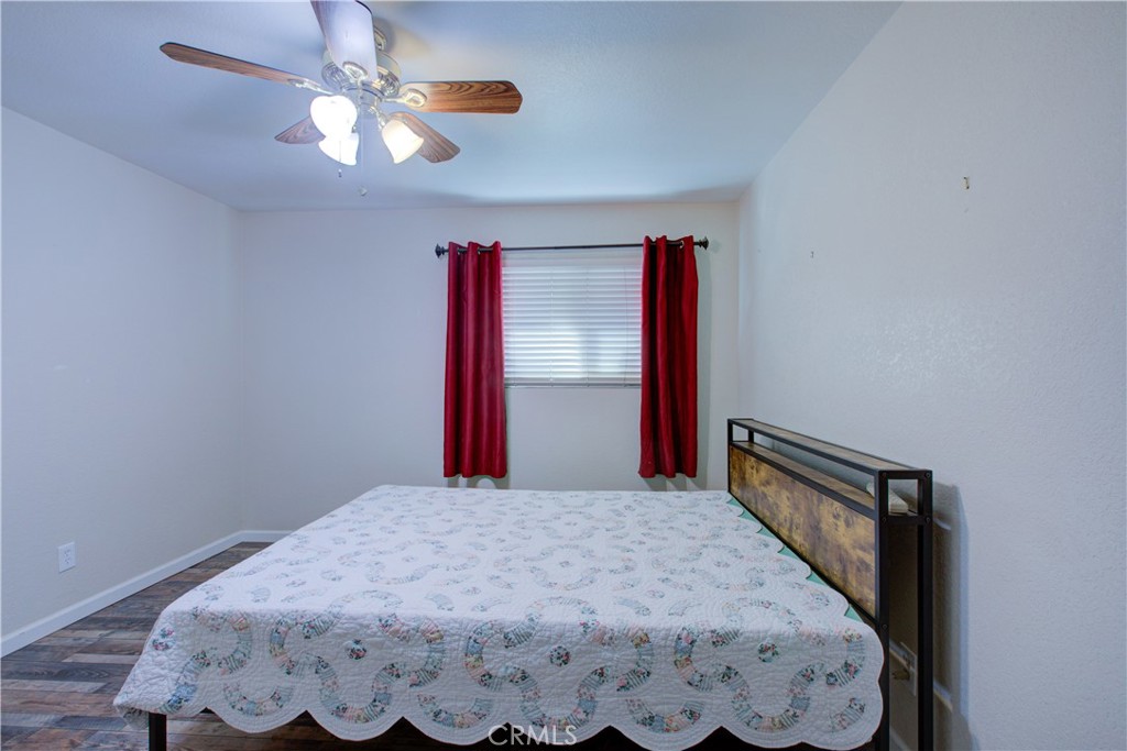 3728 Fuchsia Lane Modesto, CA 95356 - Photo 35 of 47 a bedroom with a bed and a chandelier