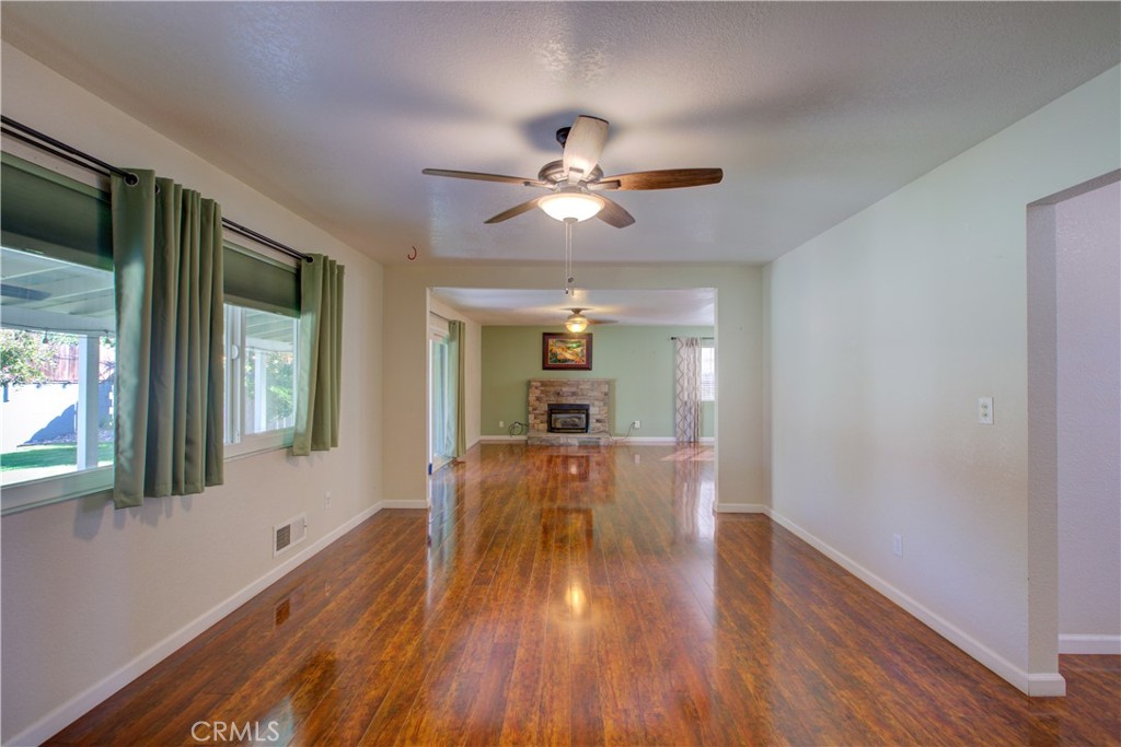 3728 Fuchsia Lane Modesto, CA 95356 - Photo 8 of 47 a view of a house with wooden floor a ceiling fan and windows