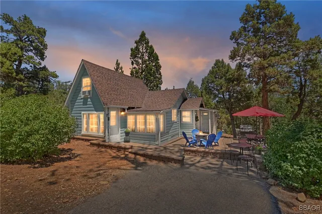 a view of a house with a tree in the background