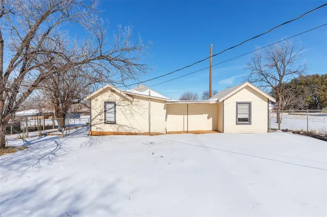 an empty room with a window and a ceiling fan