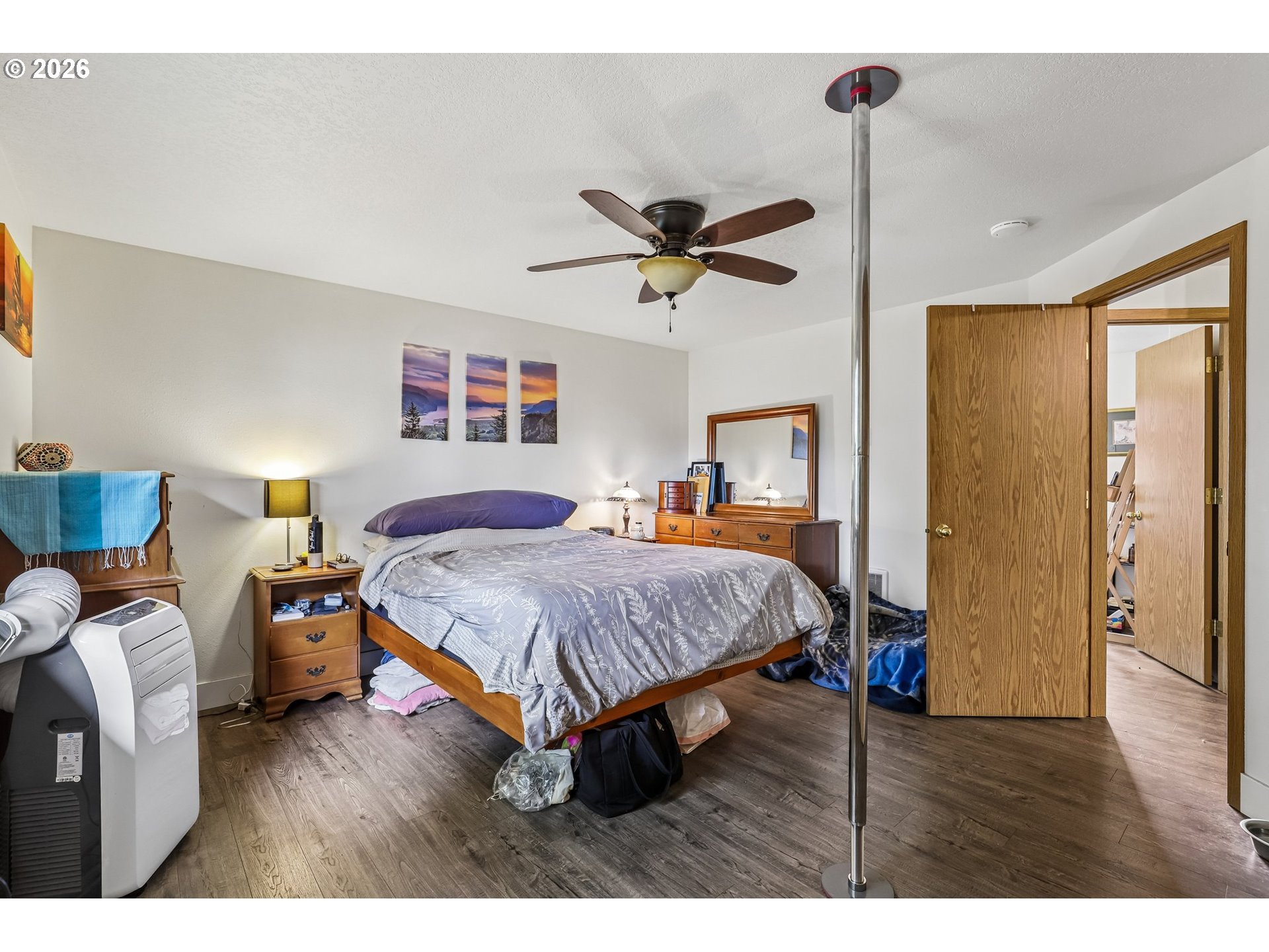608 Southeast Sumner Street Camas, WA 98607 - Photo 18 of 39 a spacious bedroom with a bed and a wooden floor