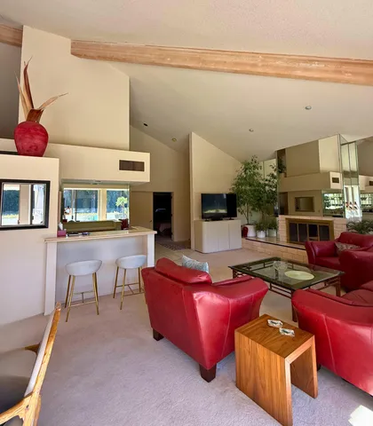 a kitchen with stainless steel appliances kitchen island granite countertop a sink and white cabinets