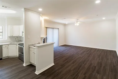 a kitchen with a refrigerator and white cabinets