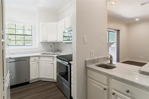 a kitchen with stainless steel appliances granite countertop a sink and dishwasher a stove with wooden floors