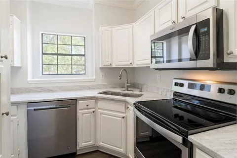 a kitchen with a stove and a microwave