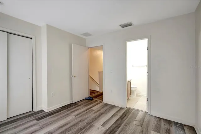 a view of a room with wooden floor and brick walls