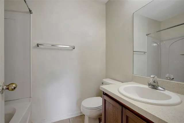 a bathroom with a sink toilet and a mirror