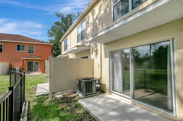 a view of a house with a glass door and outdoor space