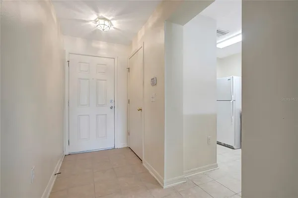 an empty room with closet and a ceiling fan