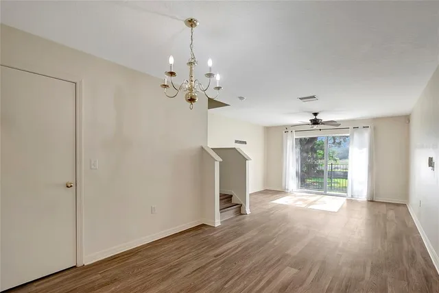 an empty room with wooden floor and a window