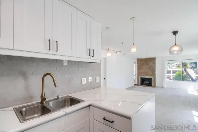 an empty room with floor to ceiling windows and closet