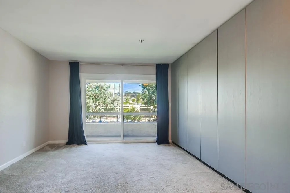 5645 Friars Road, Unit 363 San Diego, CA 92110 - Photo 21 of 74 an empty room with wooden floor and windows