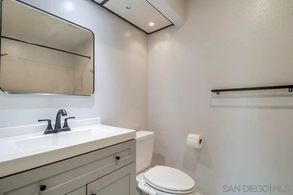 5645 Friars Road, Unit 363 San Diego, CA 92110 - Photo 35 of 74 a bathroom with a sink mirror vanity and toilet