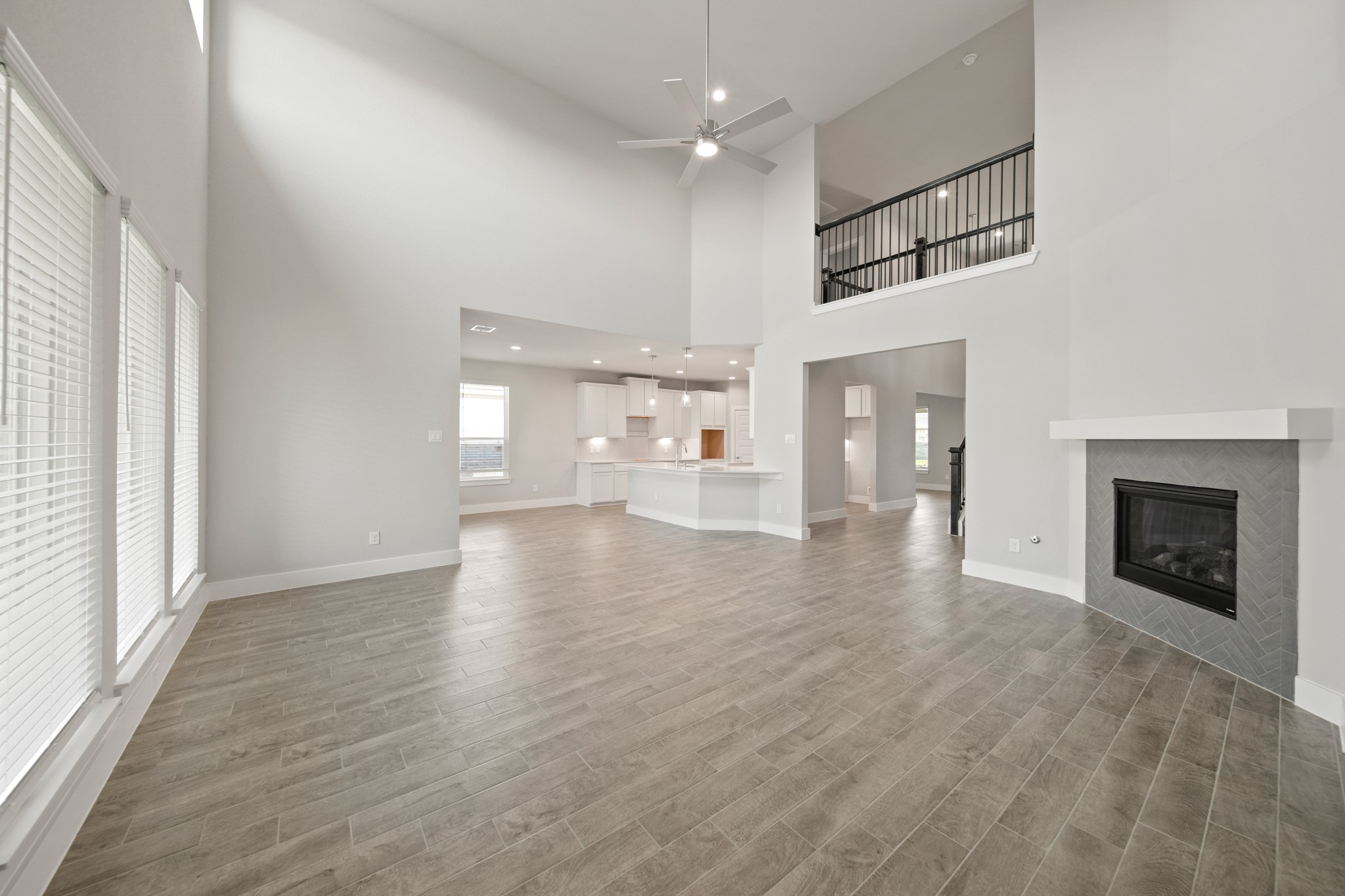 421 Piney Rocks Lane Waller, TX 77484 - Photo 13 of 47 an empty room with wooden floor fireplace and windows