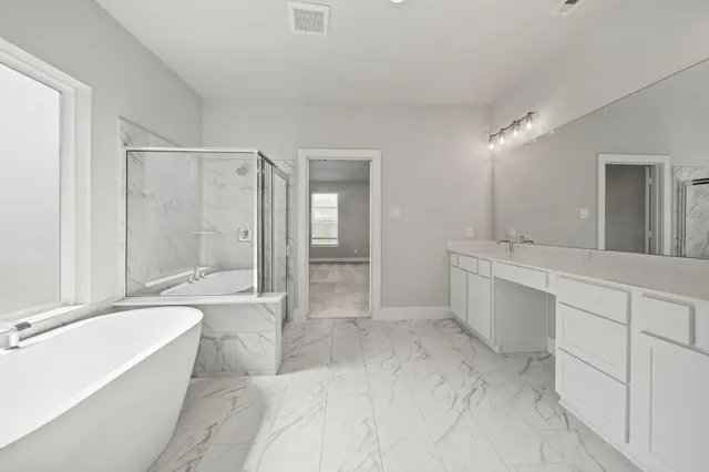 a spacious bathroom with a bathtub shower sink and mirror