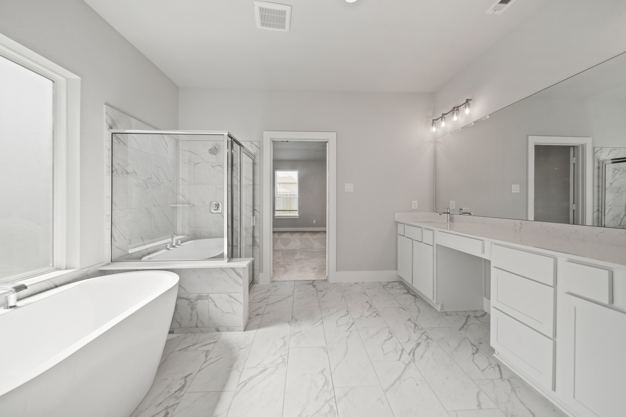 421 Piney Rocks Lane Waller, TX 77484 - Photo 17 of 47 a spacious bathroom with a bathtub shower sink and mirror