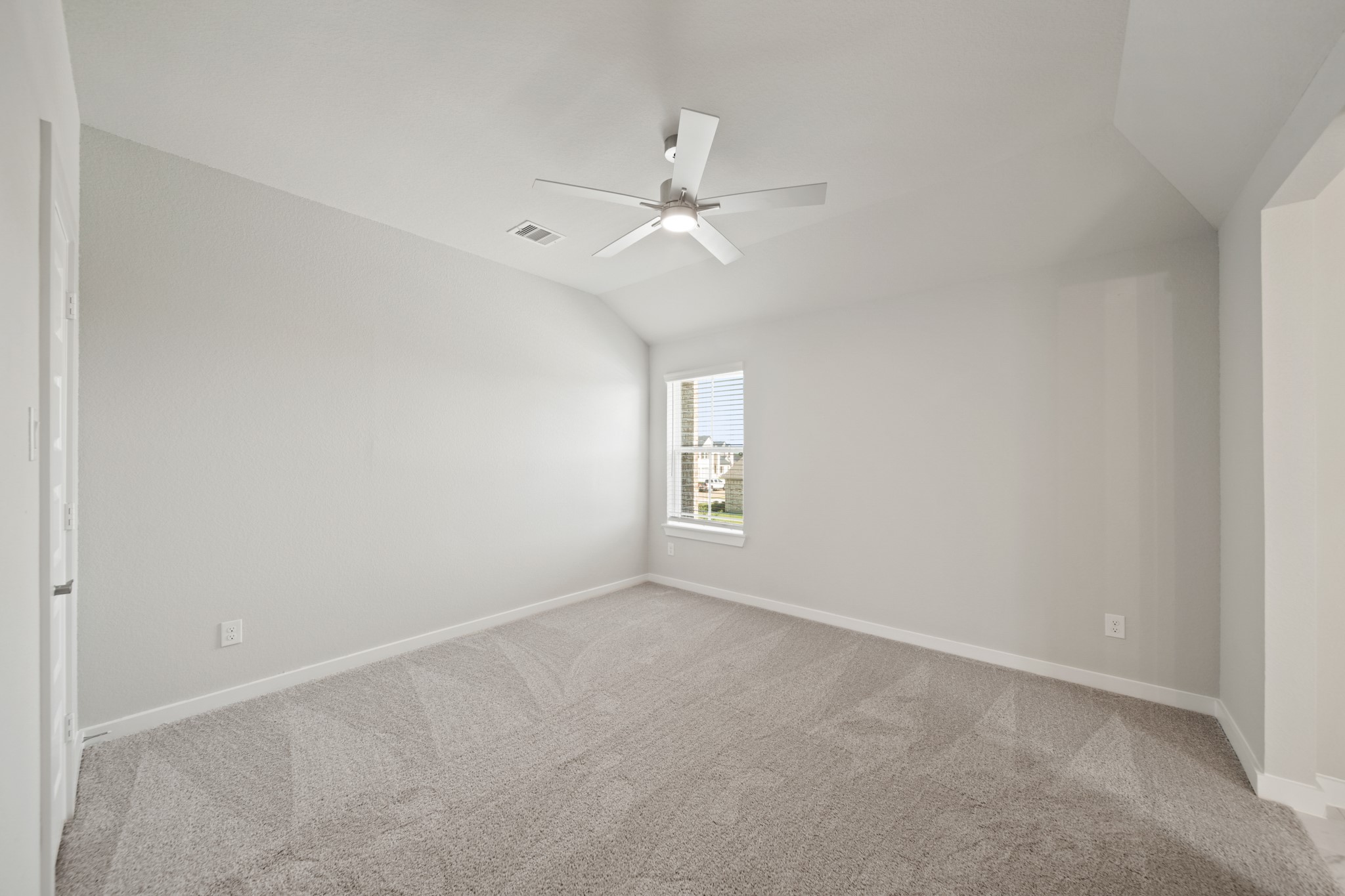 421 Piney Rocks Lane Waller, TX 77484 - Photo 21 of 47 an empty room with a window and ceiling fan