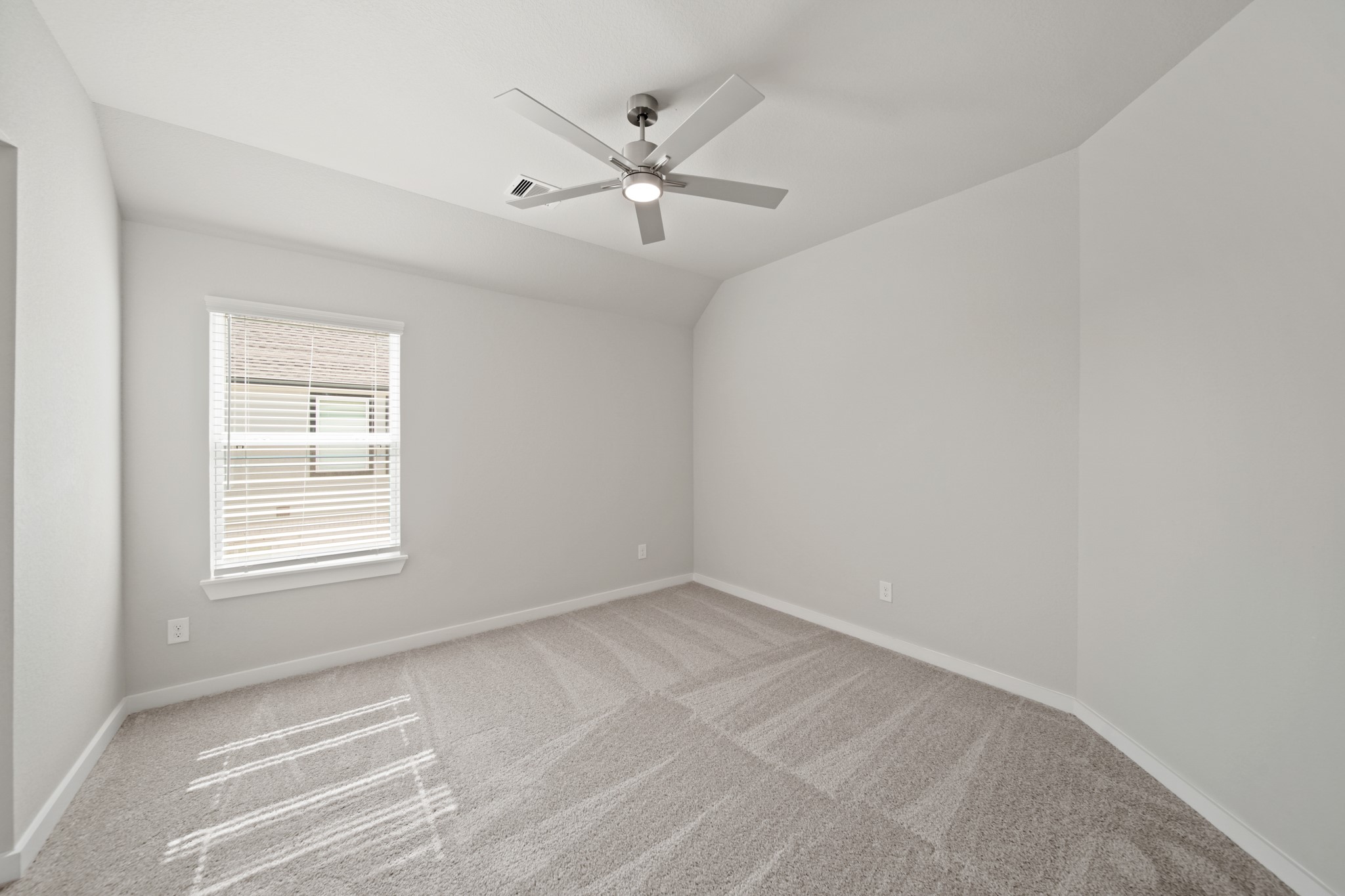 421 Piney Rocks Lane Waller, TX 77484 - Photo 23 of 47 an empty room with a window and a ceiling fan