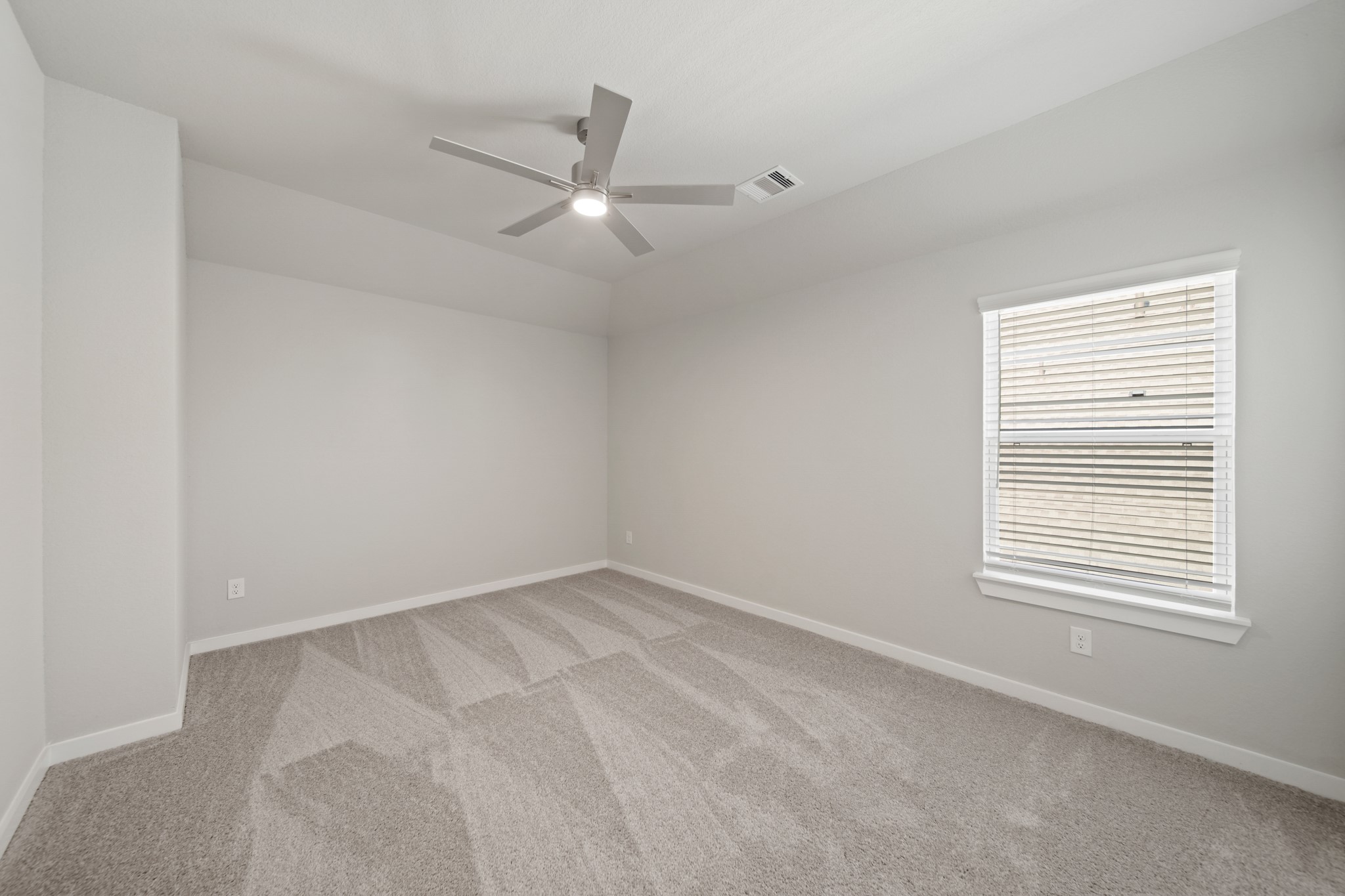 421 Piney Rocks Lane Waller, TX 77484 - Photo 25 of 47 an empty room with a window and a fan