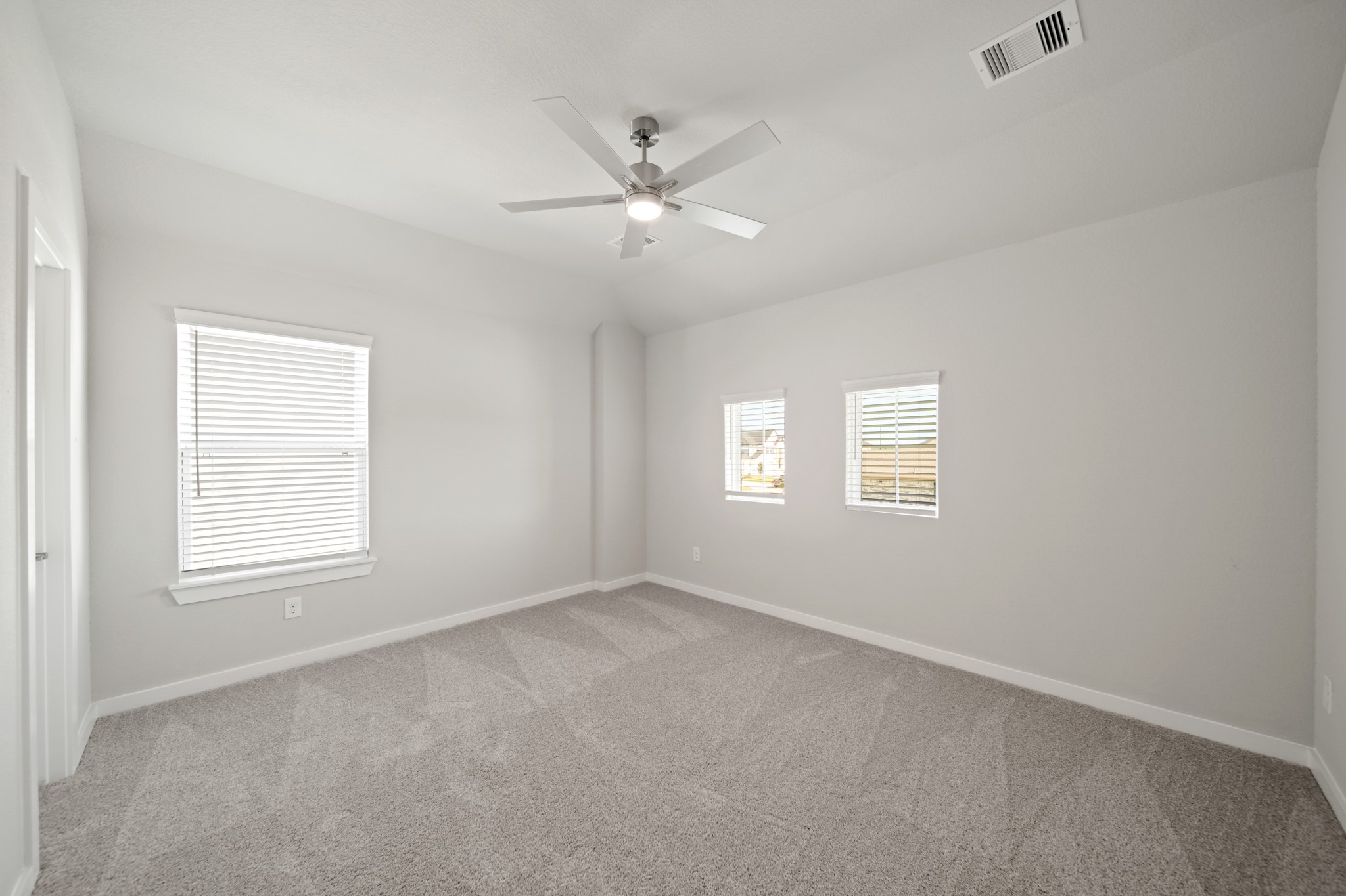 421 Piney Rocks Lane Waller, TX 77484 - Photo 26 of 47 an empty room with windows and fan