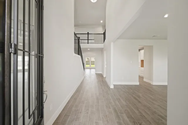 a view of a hallway view with wooden floor and staircase