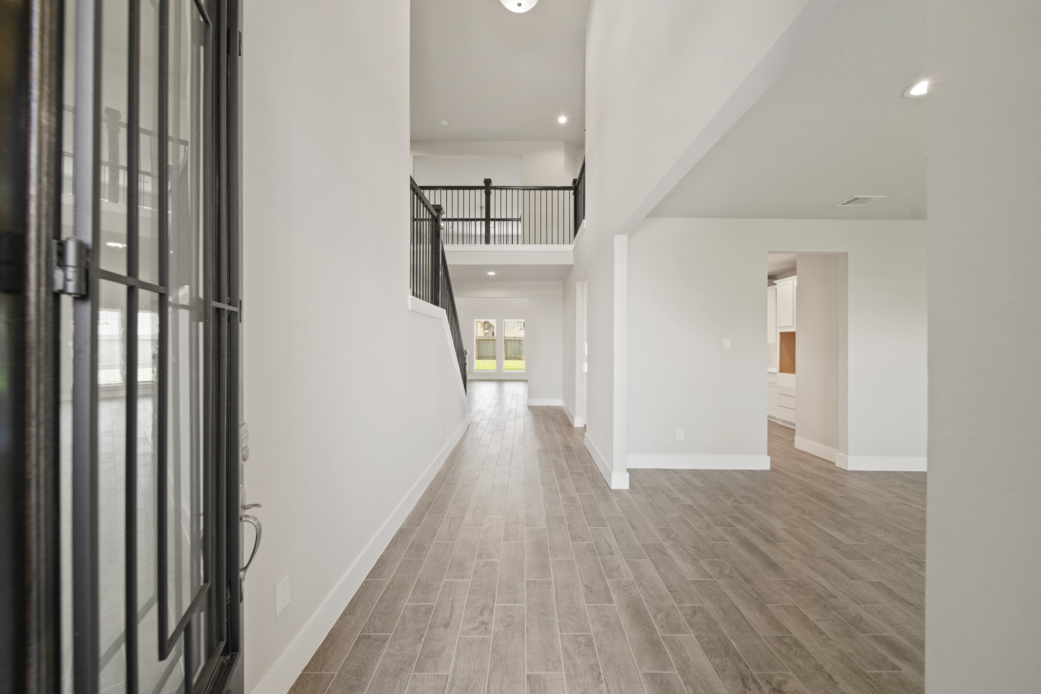 421 Piney Rocks Lane Waller, TX 77484 - Photo 4 of 47 a view of a hallway view with wooden floor and staircase