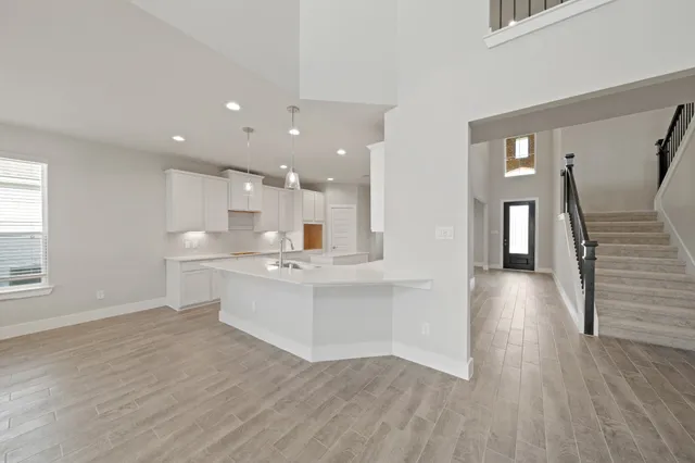 a view of kitchen and hall with wooden floor