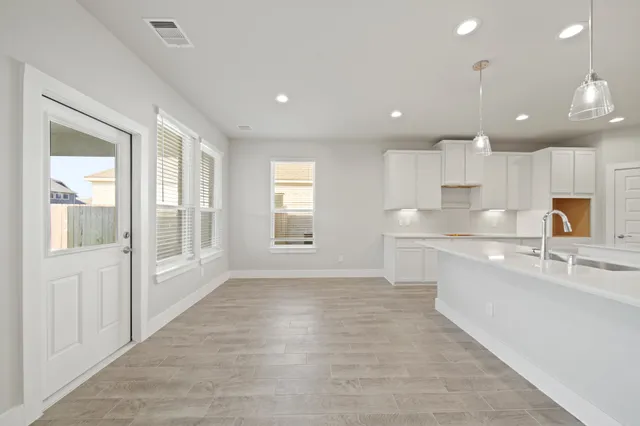 a large white kitchen with a large window