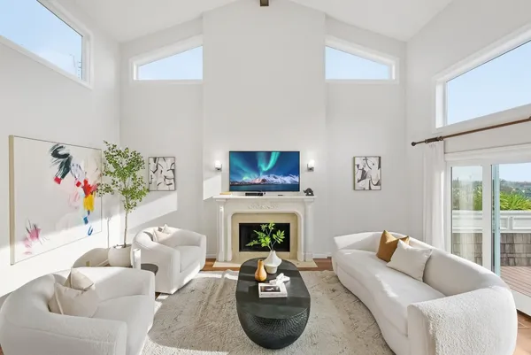 a living room with furniture fireplace and a window
