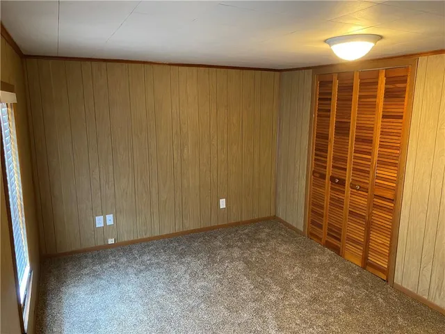 a view of an empty room with a wooden door