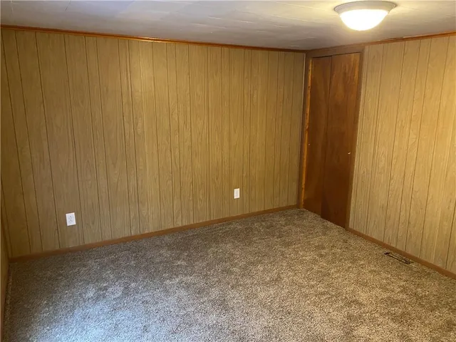 a view of an empty room with a wooden door