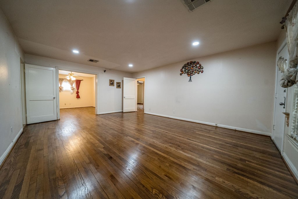 2218 Chapman Street Houston, TX 77009 - Photo 14 of 27 an empty room with hard wood floors and windows