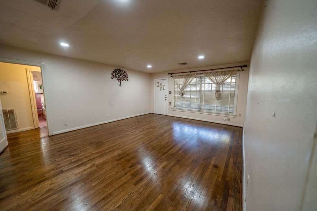 2218 Chapman Street Houston, TX 77009 - Photo 16 of 27 an empty room with wooden floor and windows