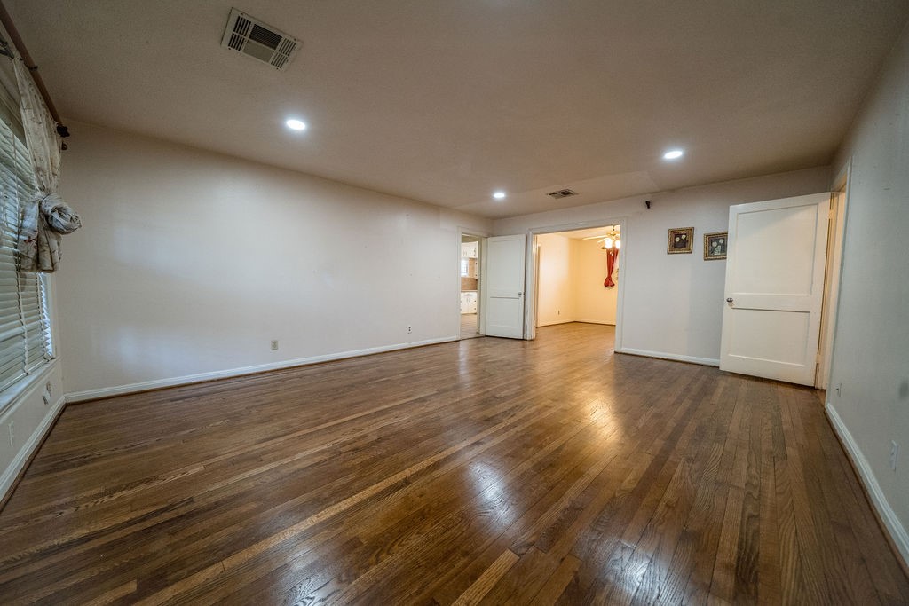 2218 Chapman Street Houston, TX 77009 - Photo 3 of 27 an empty room with wooden floor and windows