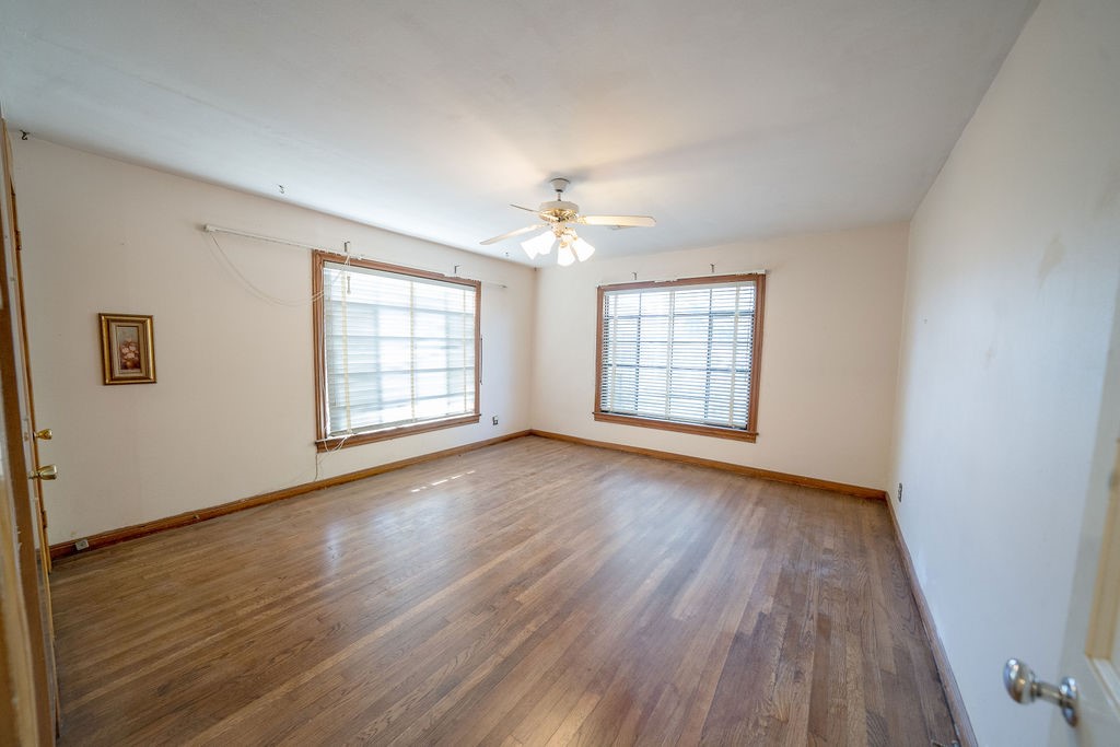 2218 Chapman Street Houston, TX 77009 - Photo 5 of 27 wooden floor in an empty room with a window