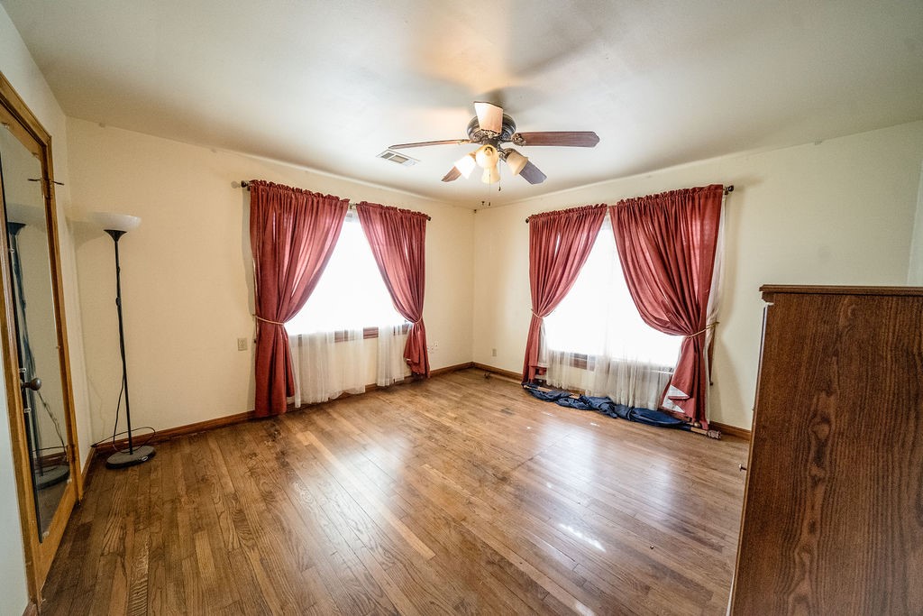 2218 Chapman Street Houston, TX 77009 - Photo 6 of 27 wooden floor in an empty room with a window