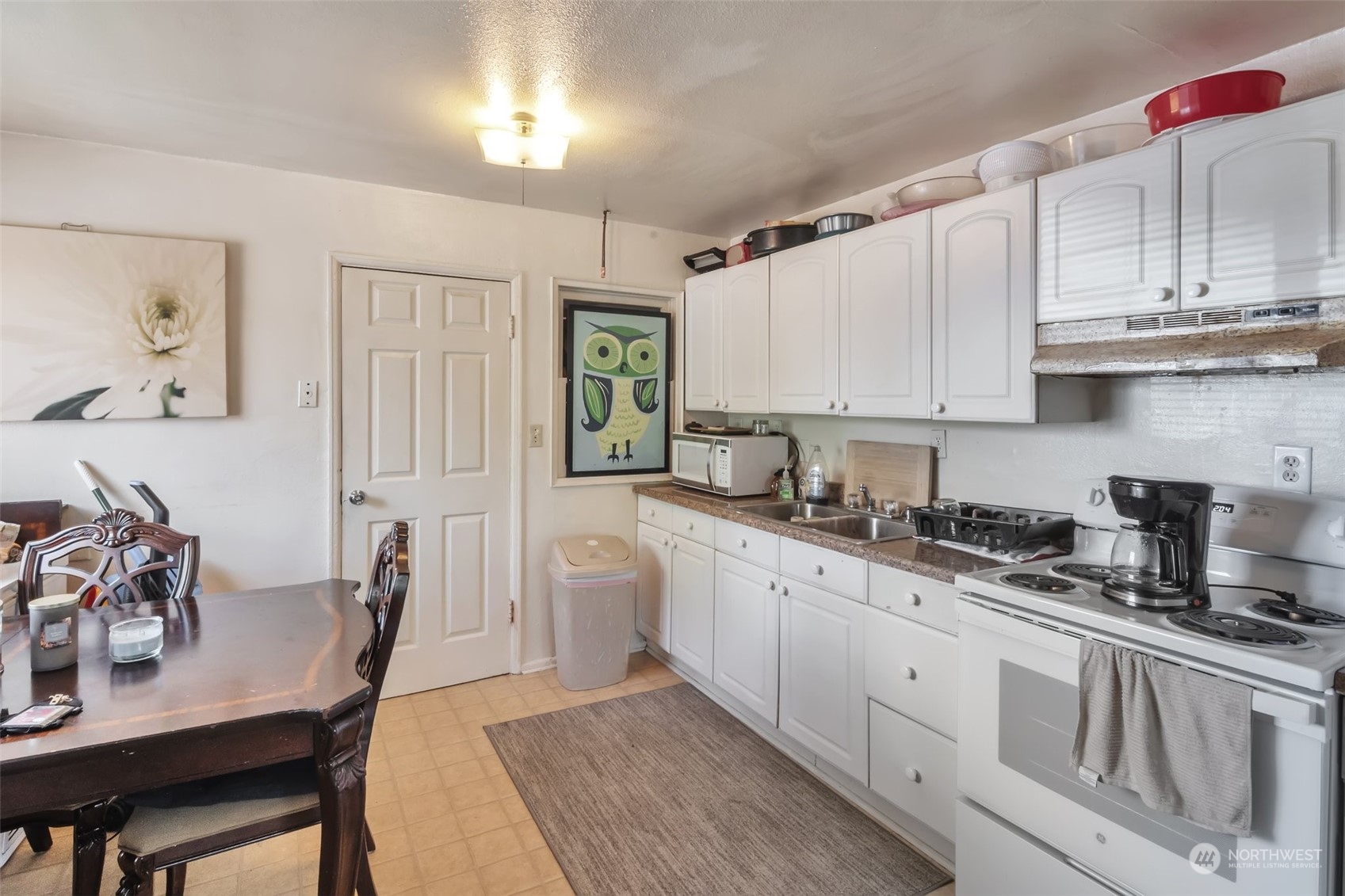 108 Oak Street Bremerton, WA 98310 - Photo 3 of 25 a kitchen with white cabinets and sink