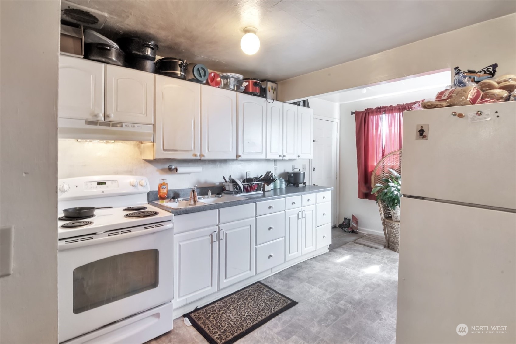 108 Oak Street Bremerton, WA 98310 - Photo 10 of 25 a kitchen with granite countertop white cabinets and white appliances