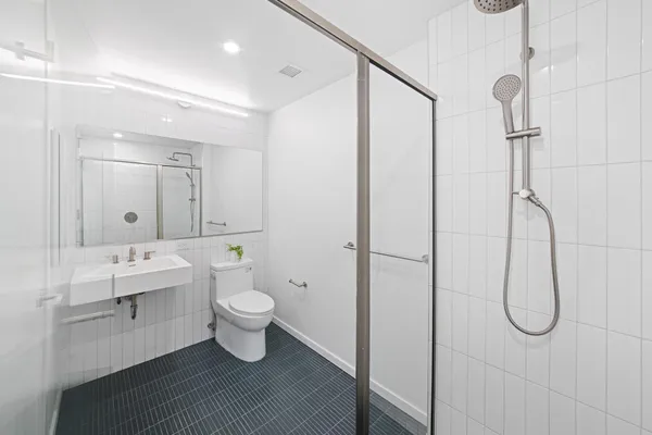 a bathroom with a shower and sink