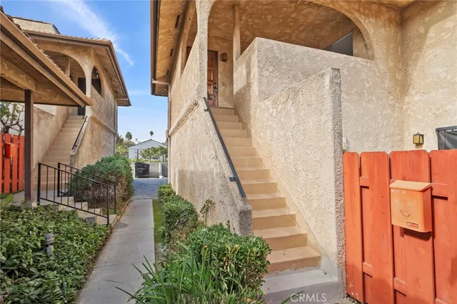 a view of a pathway of a house with a yard