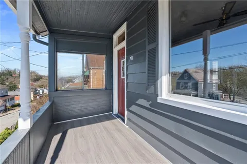 a room with a large window and a rug