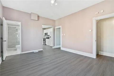 a view of wooden floor and windows in a room