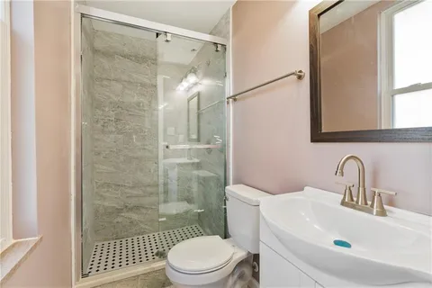 a bathroom with a sink toilet and shower