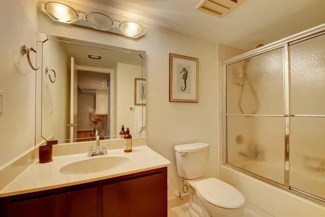 a bathroom with a sink toilet and shower