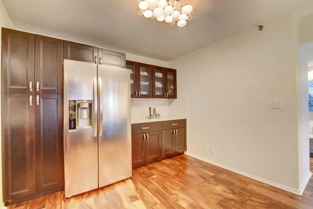 a kitchen with stainless steel appliances granite countertop a refrigerator and a sink